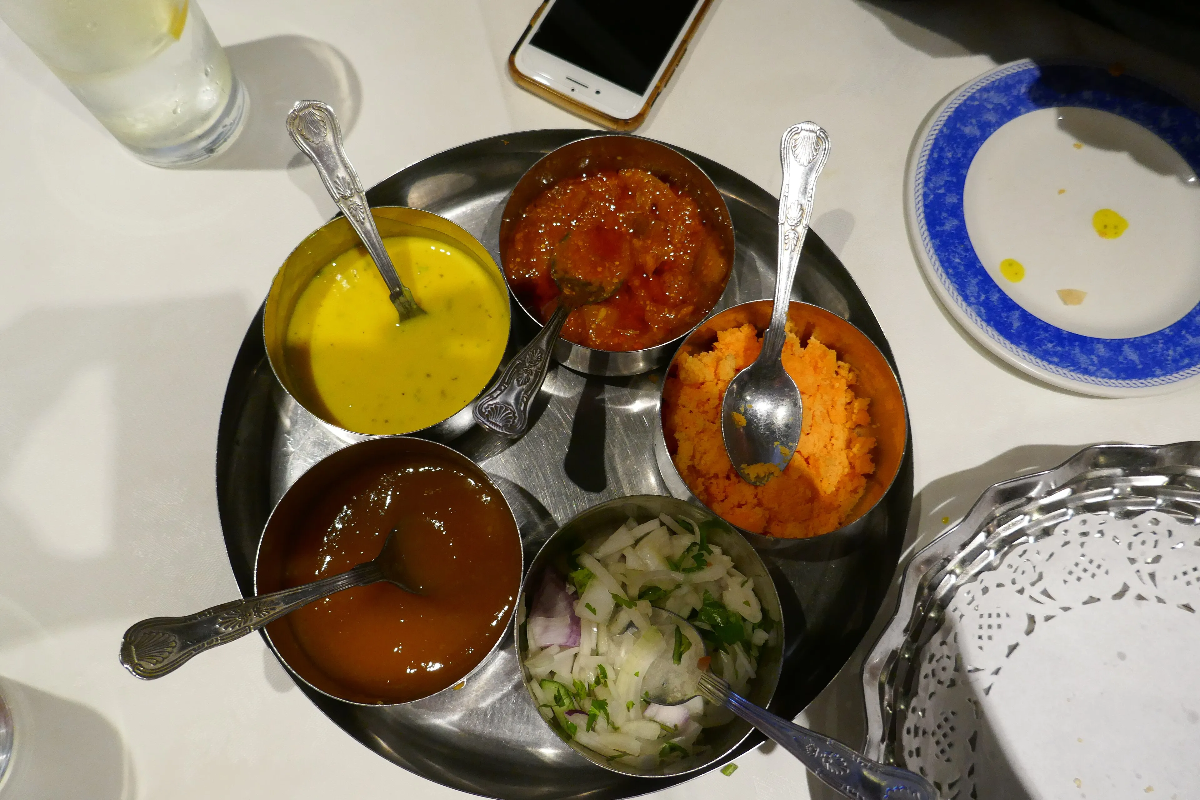 A table of Indian curries and accompaniments at a Brick Lane restaurant