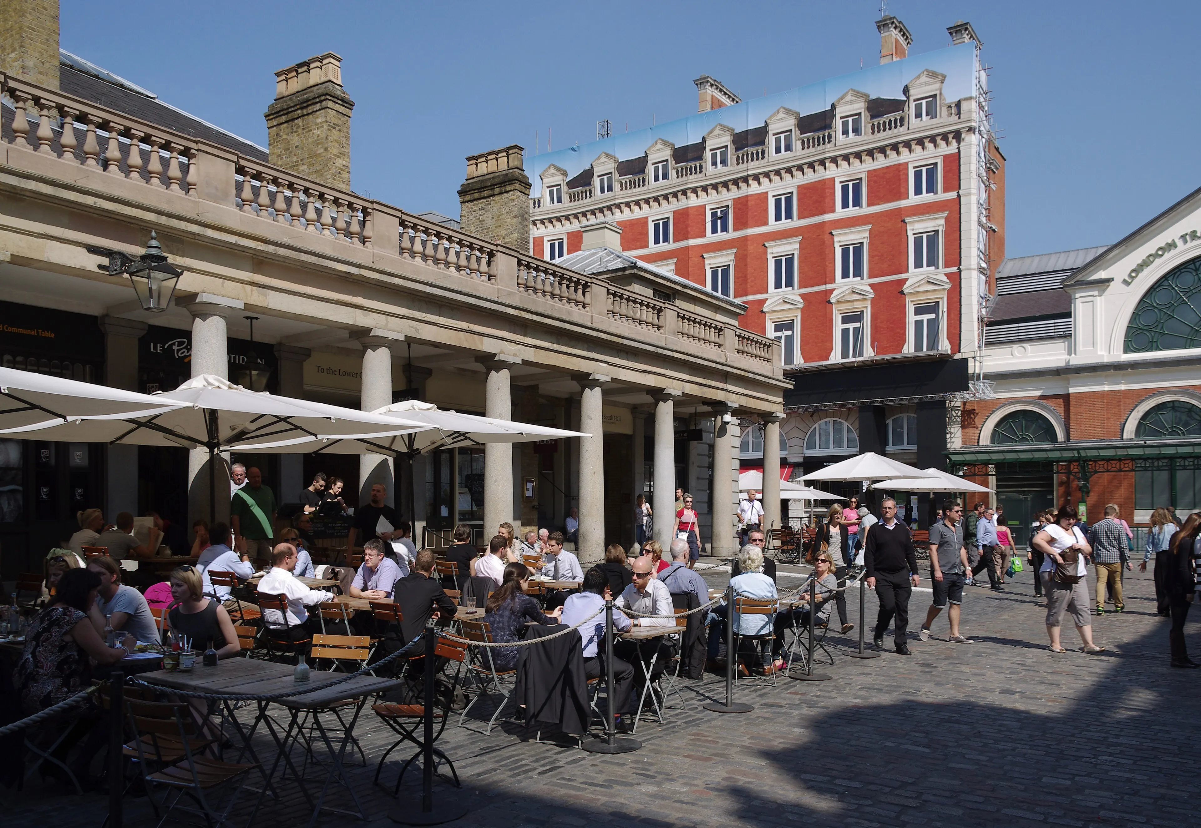 Outdoor tables and historic market buildings in Covent Garden Piazza